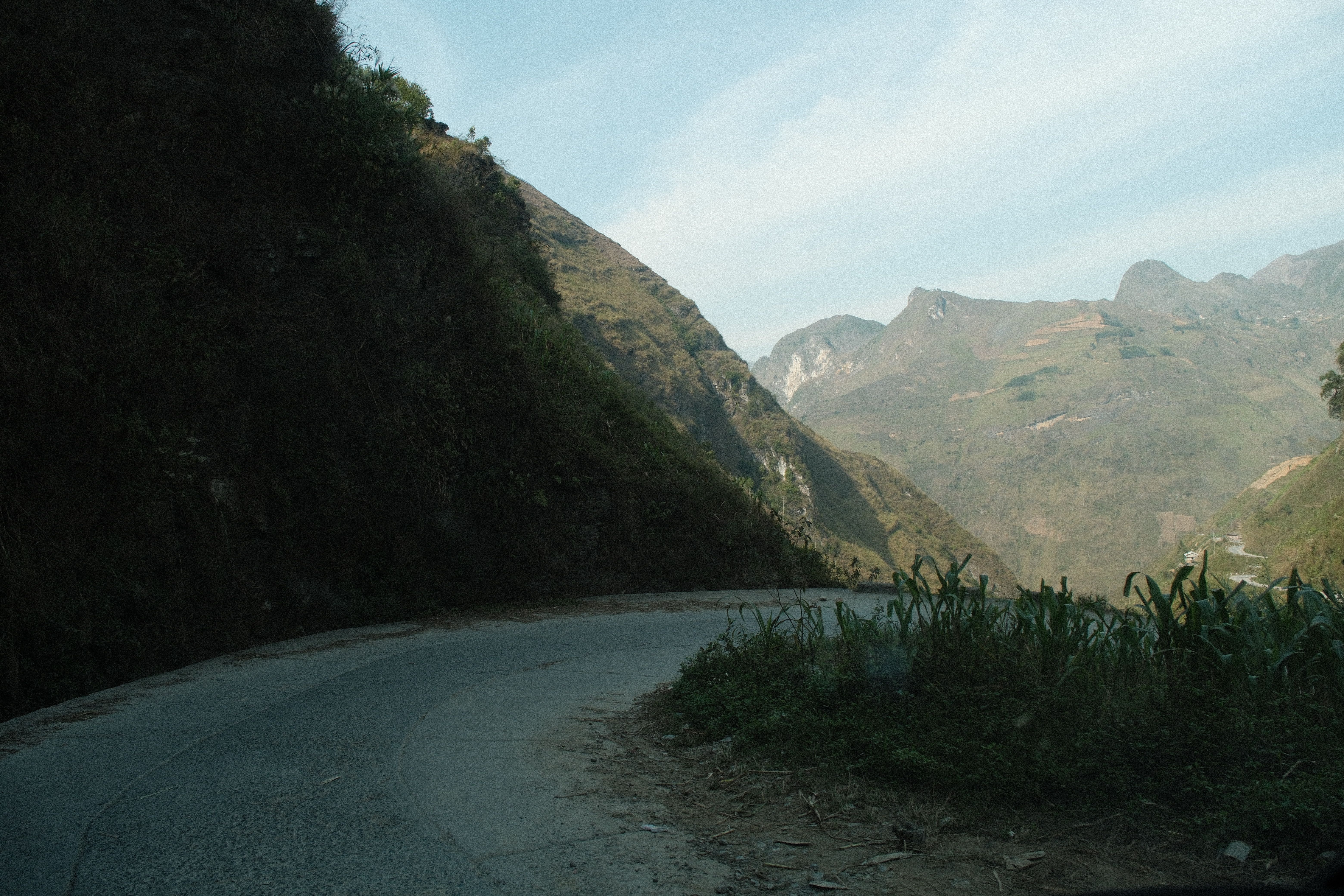 Explore the tranquil beauty of a winding mountain road with lush greenery and ma
