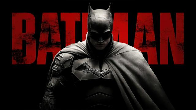 Batman in dark tactical armor stands centered in front of distressed red text spelling BATMAN against a solid black background.