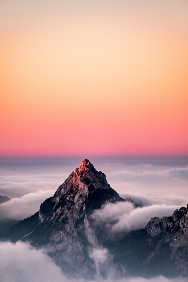 aerial-view-mountain-covered-fog-beautiful-pink-sky