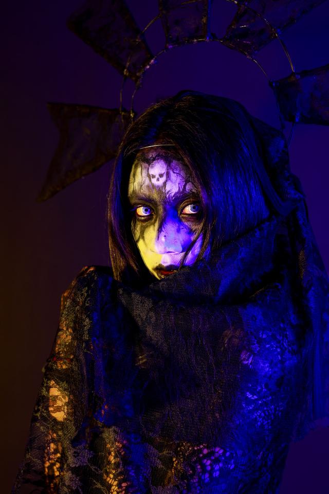 Haunting gothic portrait featuring eerie makeup and dark lighting, creating a my