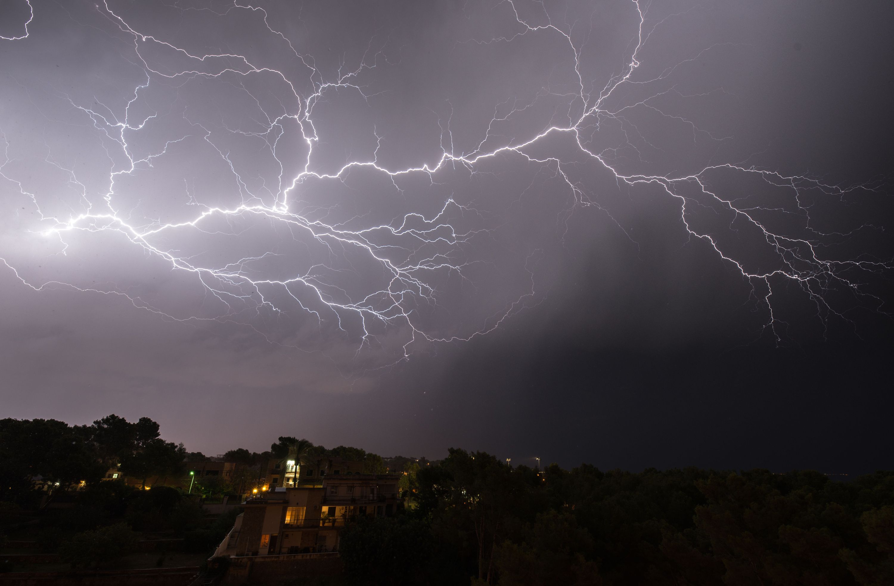 A breathtaking view of a lightning storm illuminating the sky during the night.