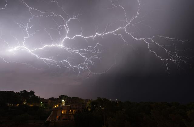 A breathtaking view of a lightning storm illuminating the sky during the night.